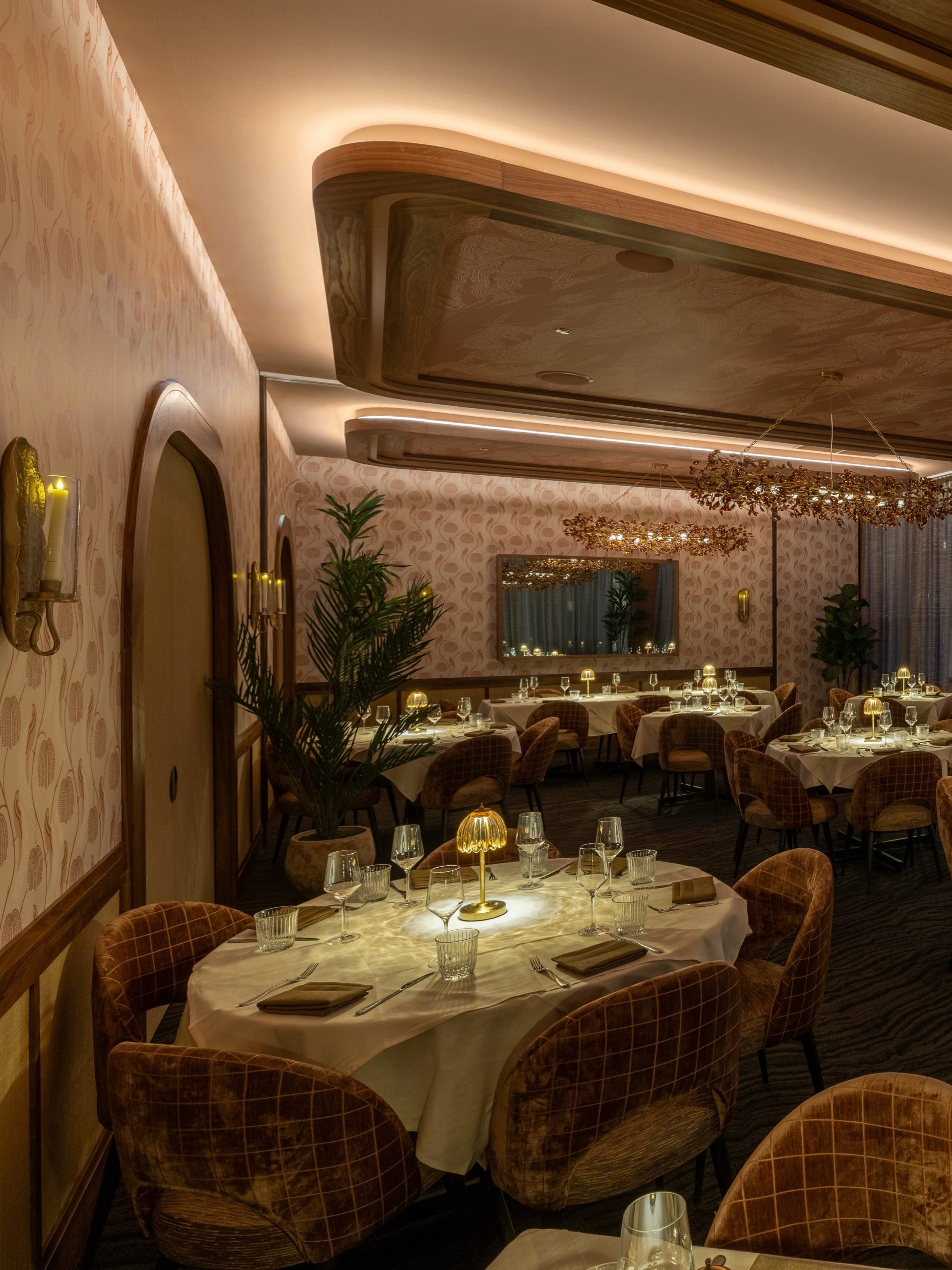 Arla Chicago dining room with terracotta velvet chairs white tablecloths and warm lighting