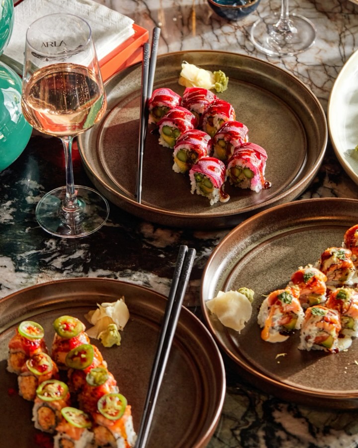 Arla Chicago maki rolls and etched ARLA wine glass on marble table