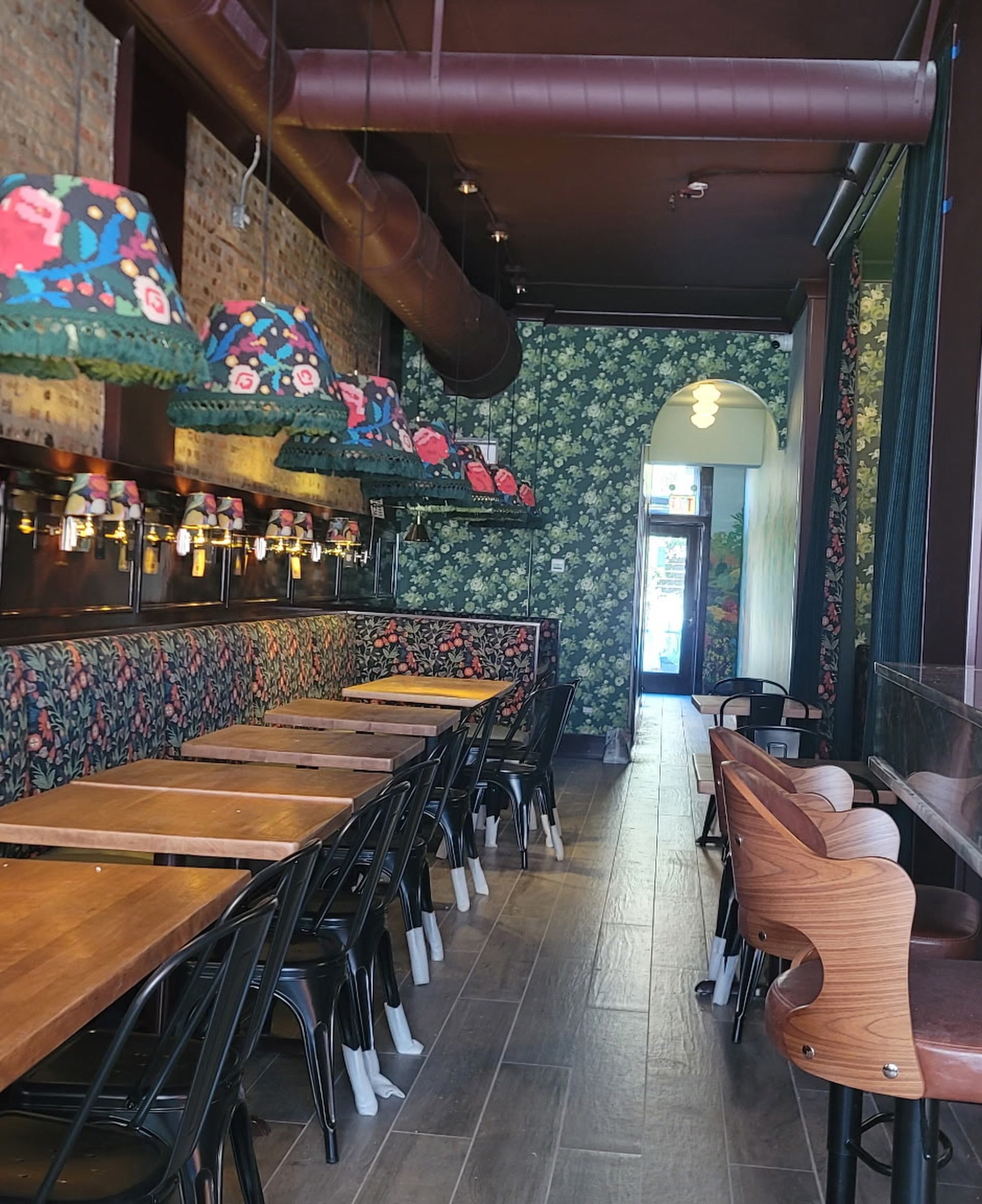 De Colores Chicago dining room with floral banquette and fringe pendant lamps in Andersonville