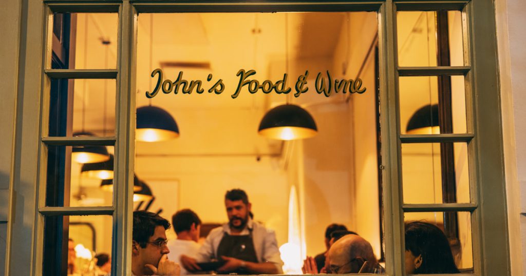 John's Food and Wine Chicago storefront window looking into the dining room