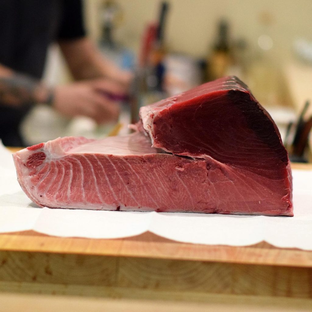 Kyōten Chicago bluefin tuna loin on wooden prep board at the omakase counter