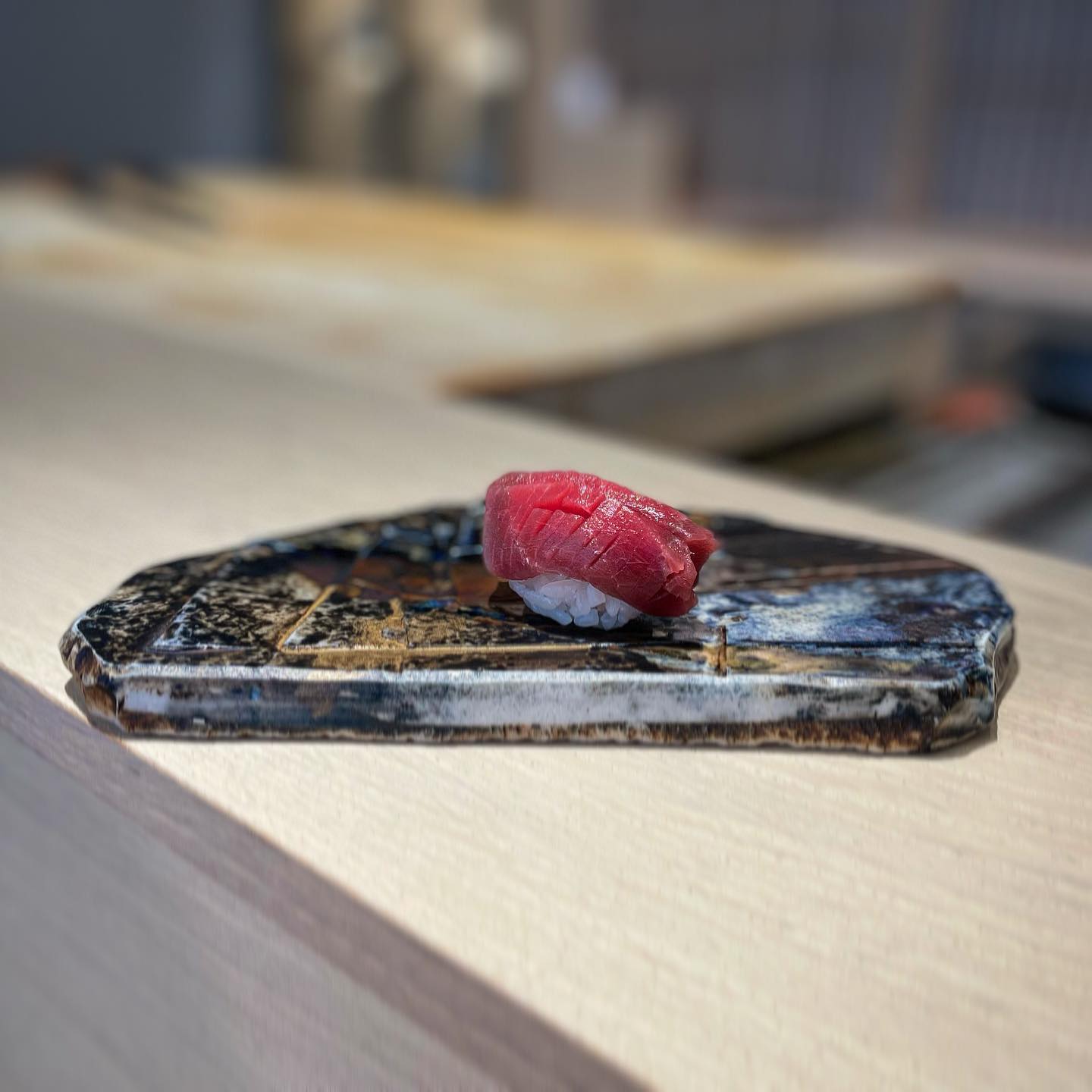 Kyōten Chicago tuna nigiri on ceramic plate at the omakase counter