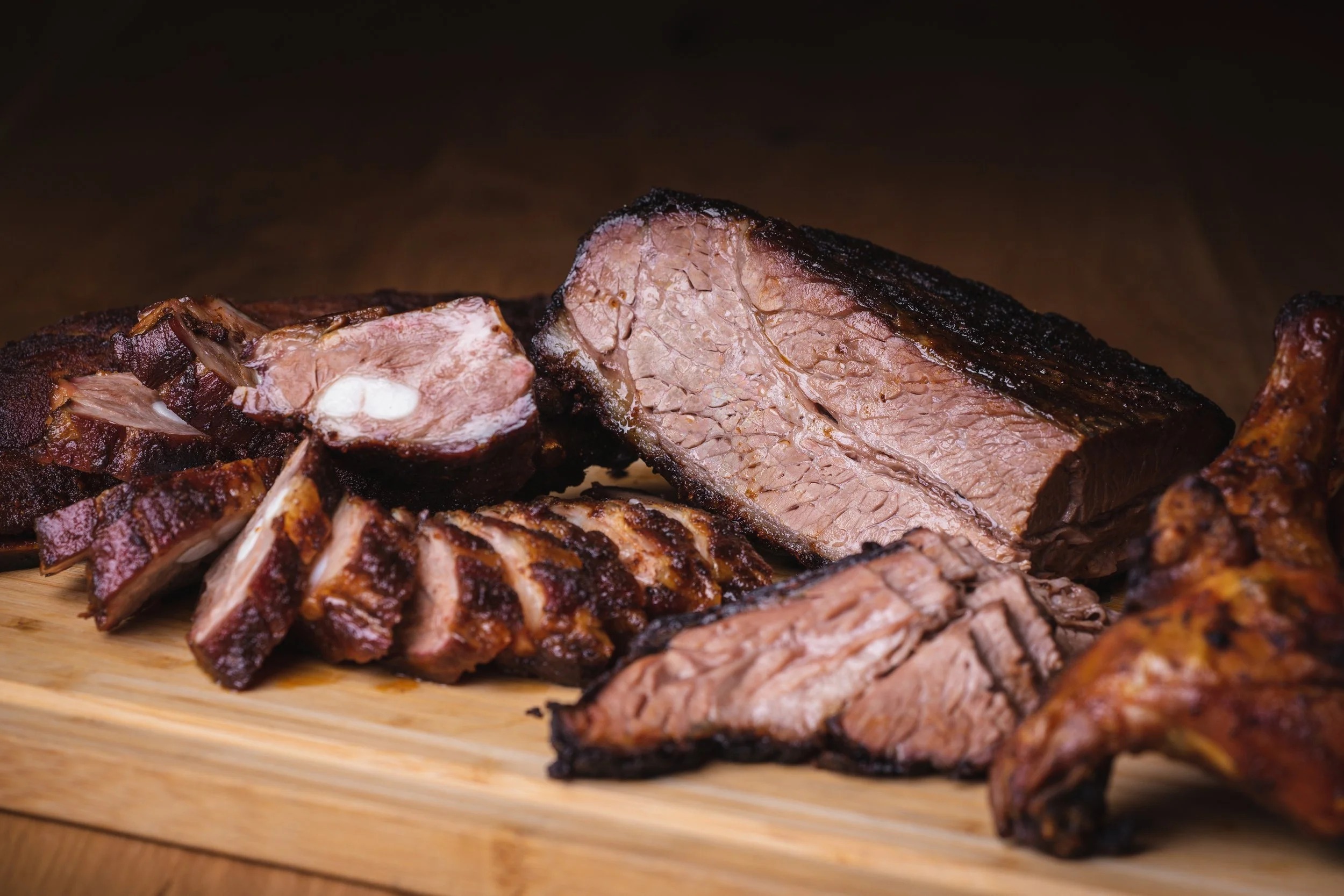 Little Betty Smokehouse Chicago-style BBQ board with smoked brisket, ribs, and chicken