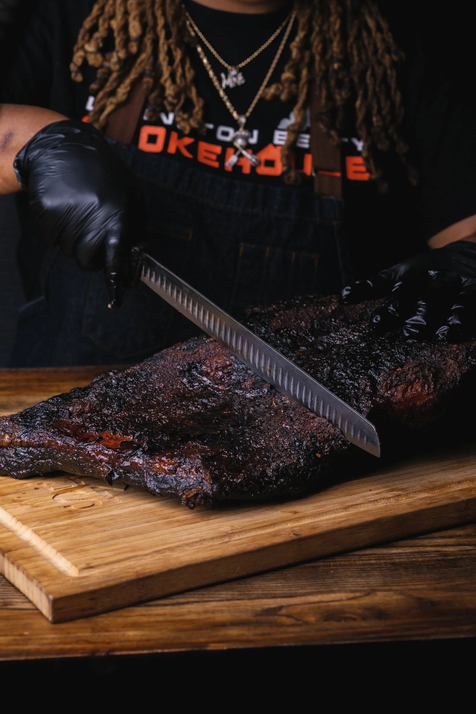 Chef Dominique Leach slicing smoked brisket at Lexington Betty Smokehouse for Little Betty campus menu