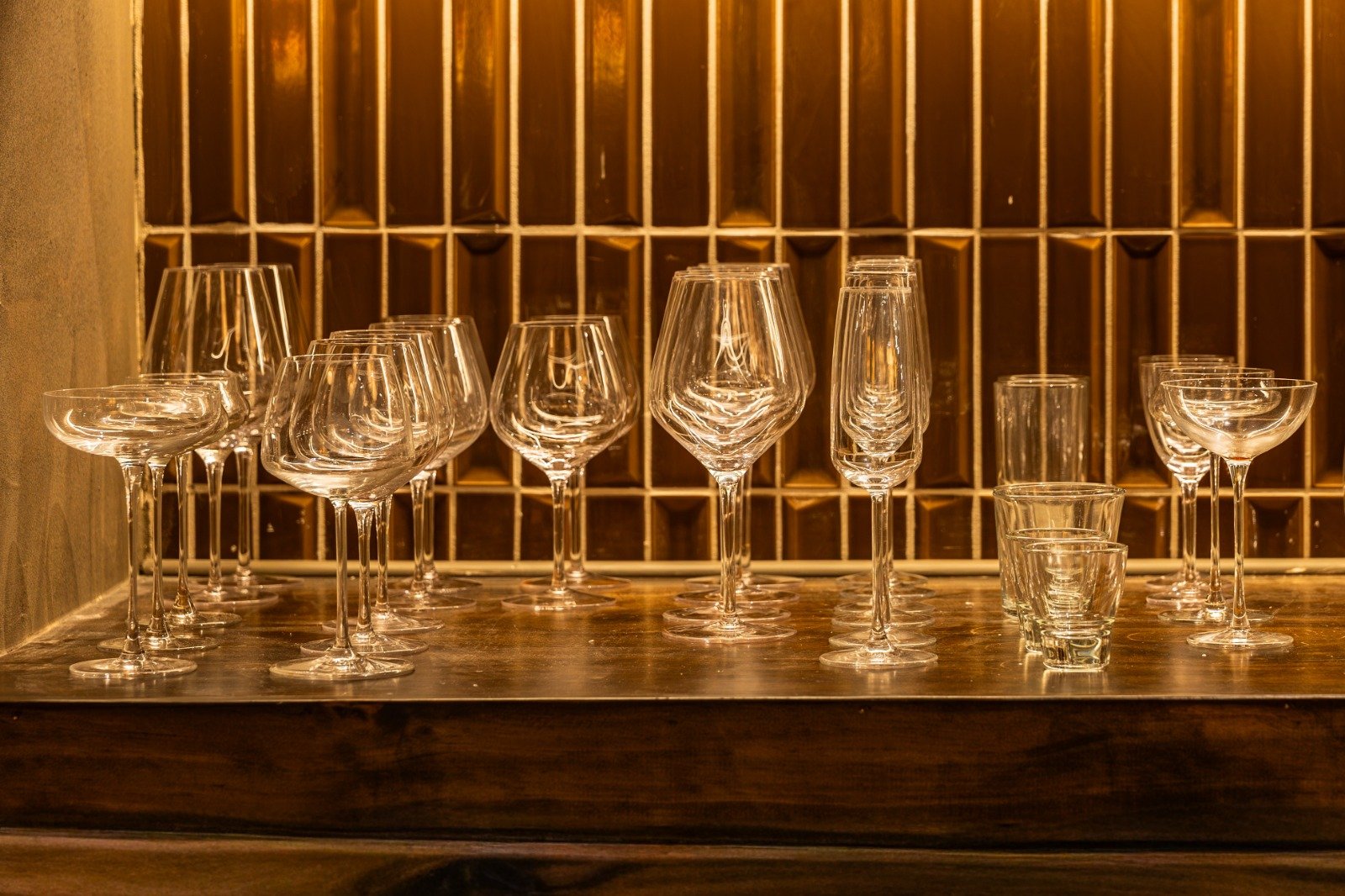 Osteria Gilberto Chicago wine and cocktail glassware on the bar against tiled wall