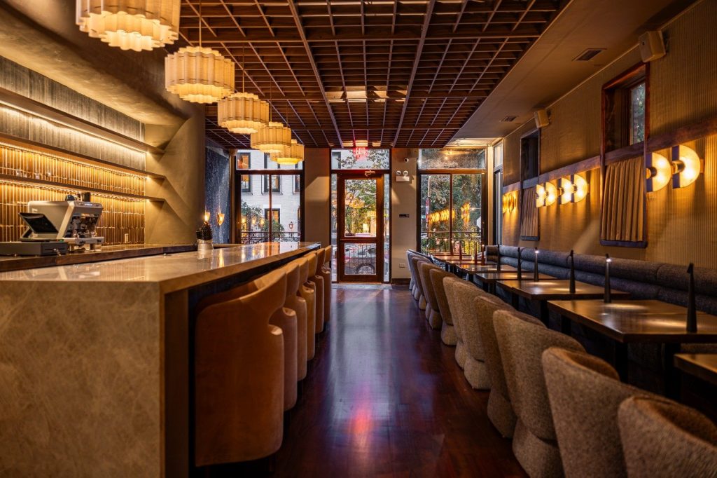 Osteria Gilberto Chicago Lincoln Park dining room with marble bar, banquette, and warm pendant lights