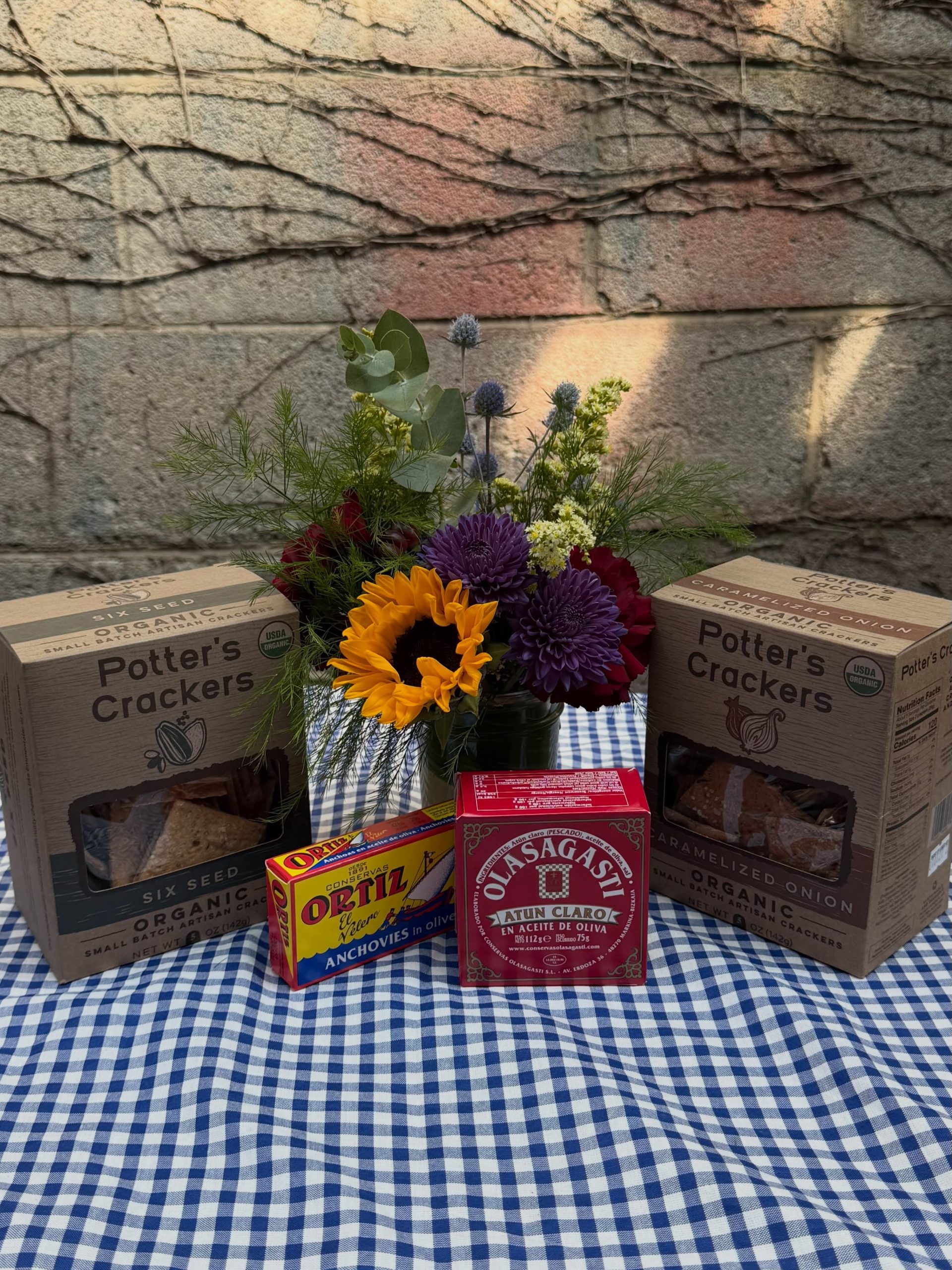 Piccadilly Market Lincoln Park pantry staples with flowers crackers and tinned fish
