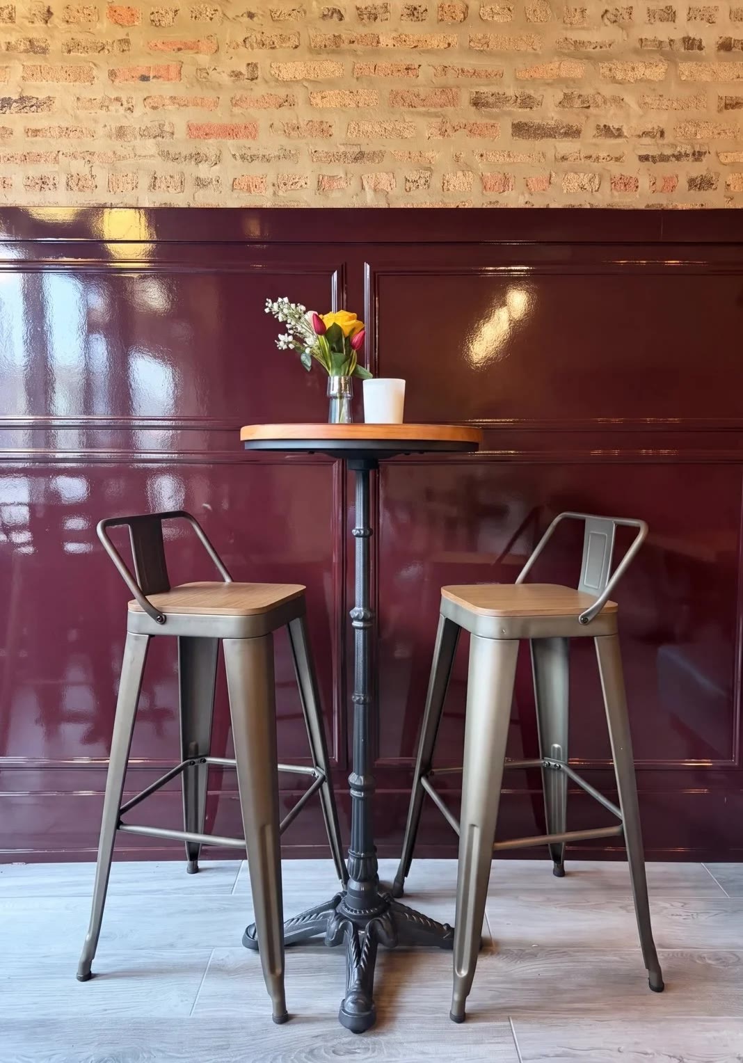 De Colores Chicago intimate two-top seating against burgundy paneling and brick