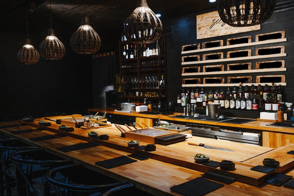 Sushi by Scratch Chicago 10-seat omakase counter with woven pendant lights and wooden sushi bar