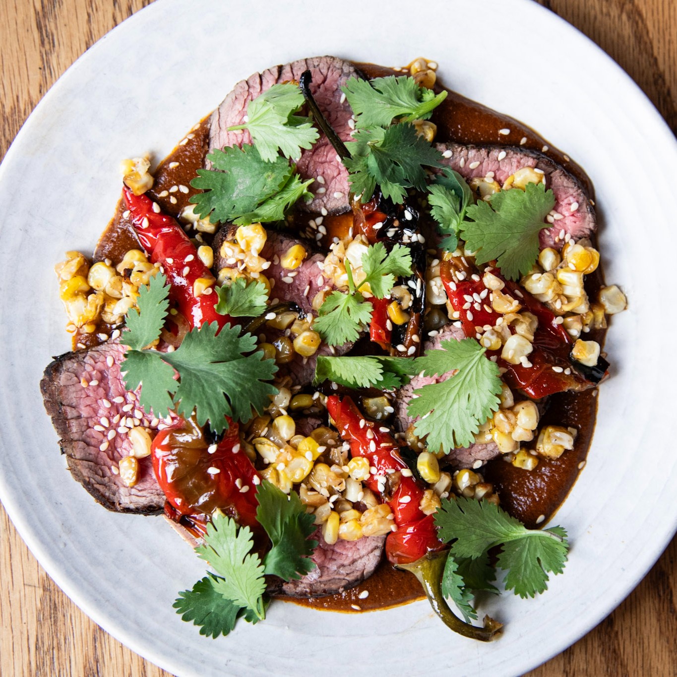 Grilled butcher steak with cashew harissa, roasted corn and peppers at avec in Chicago