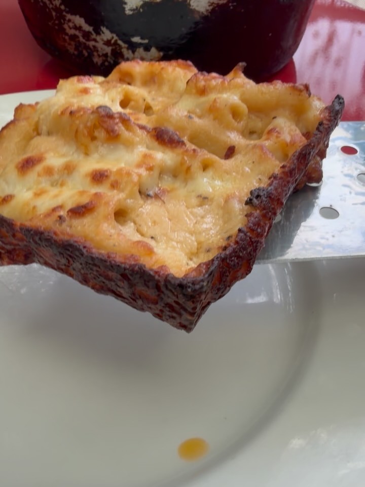 A square slice of Macaroni Gratin Papa Louis with a browned, crackly cheese crust at Chez Poulet Chicago
