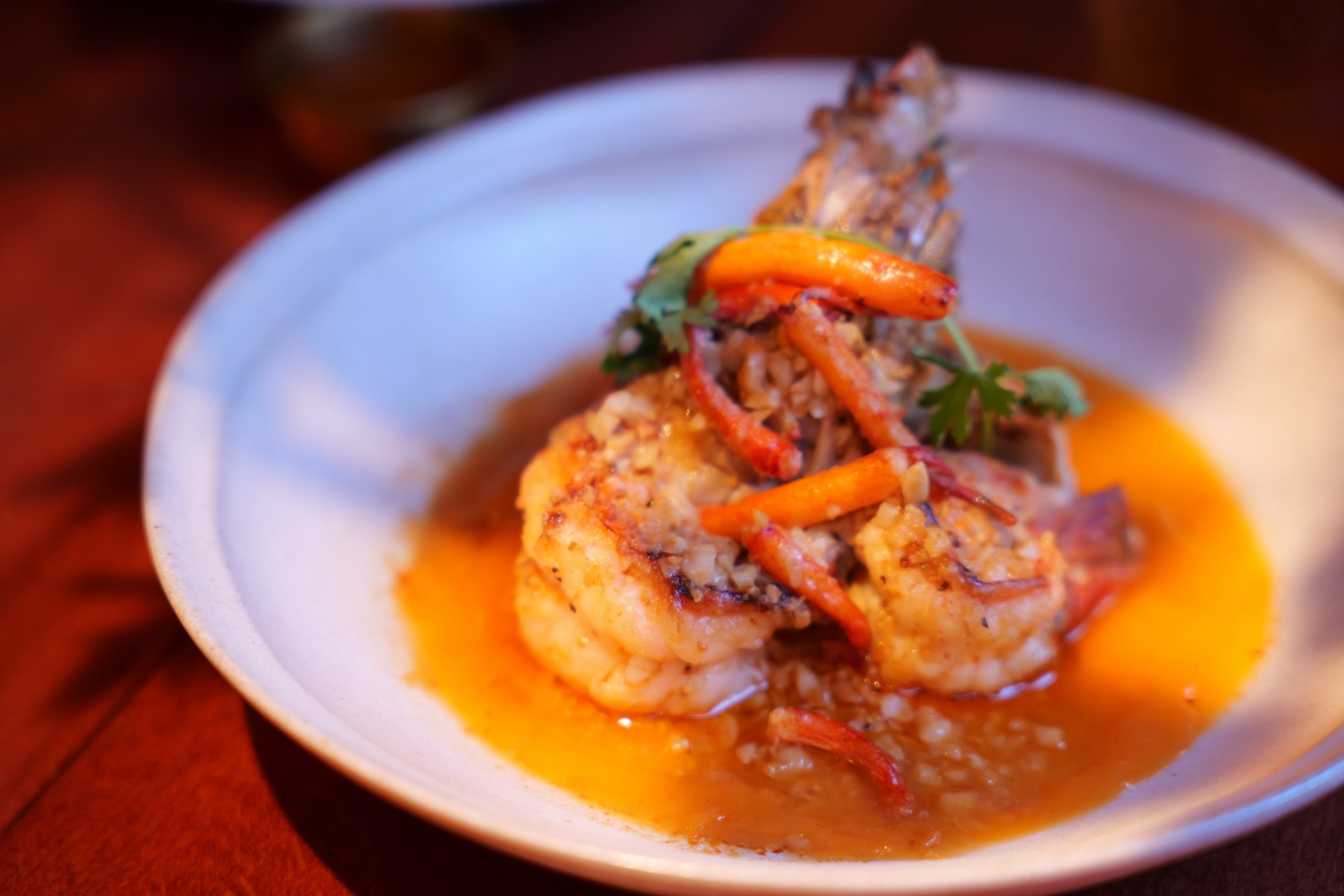 Chiang Mai Night Bazaar grilled shrimp plate in a bright orange sauce with cilantro