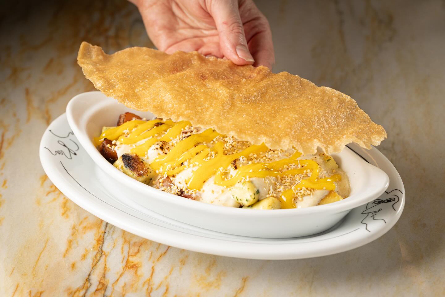 Parisian gnocchi with gruyere, ham and egg yolk at Creepies in Chicago
