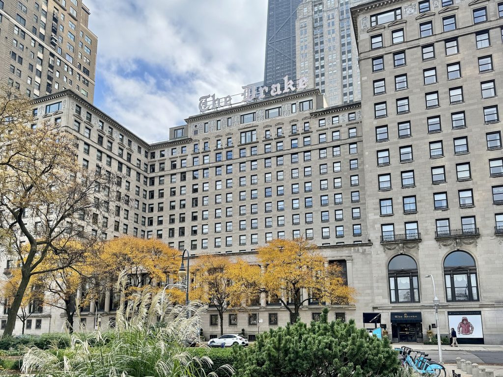 The Drake Hotel in Chicago framed by golden autumn trees on Michigan Avenue