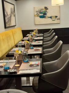 Goosefoot Chicago Lincoln Square dining room with mustard velvet banquettes and set tables