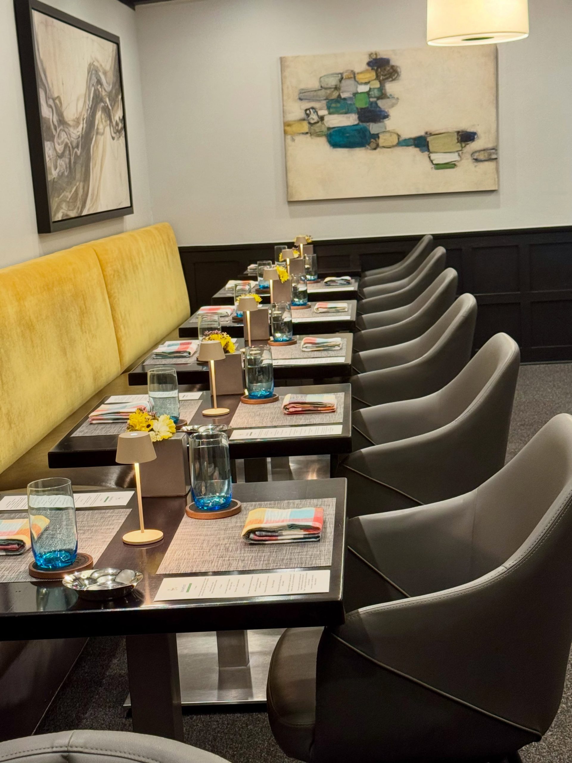 Goosefoot Chicago Lincoln Square dining room with mustard velvet banquettes and set tables