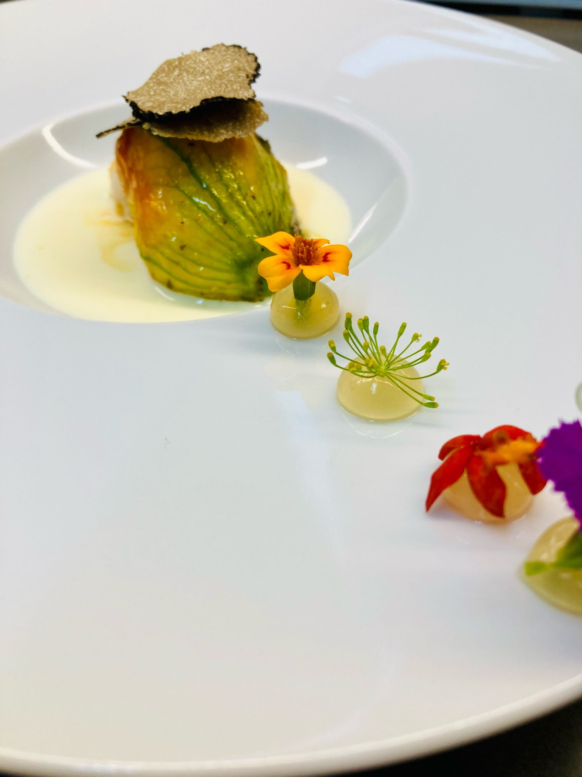 Goosefoot Chicago zucchini blossom crab soufflé with Burgundy truffle shavings