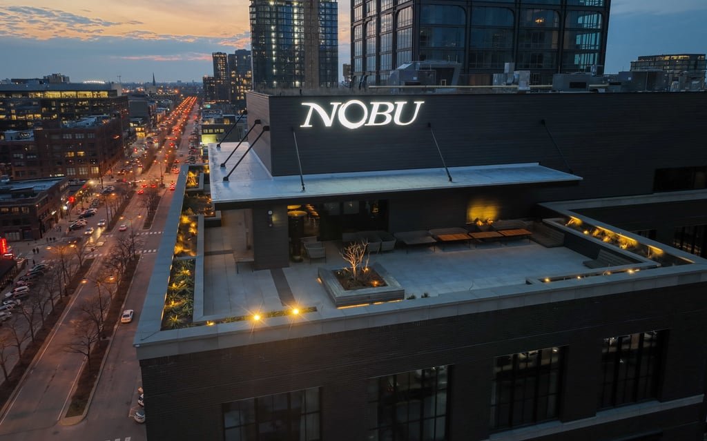 The rooftop terrace of Nobu Hotel Chicago at dusk, with the West Loop skyline behind it