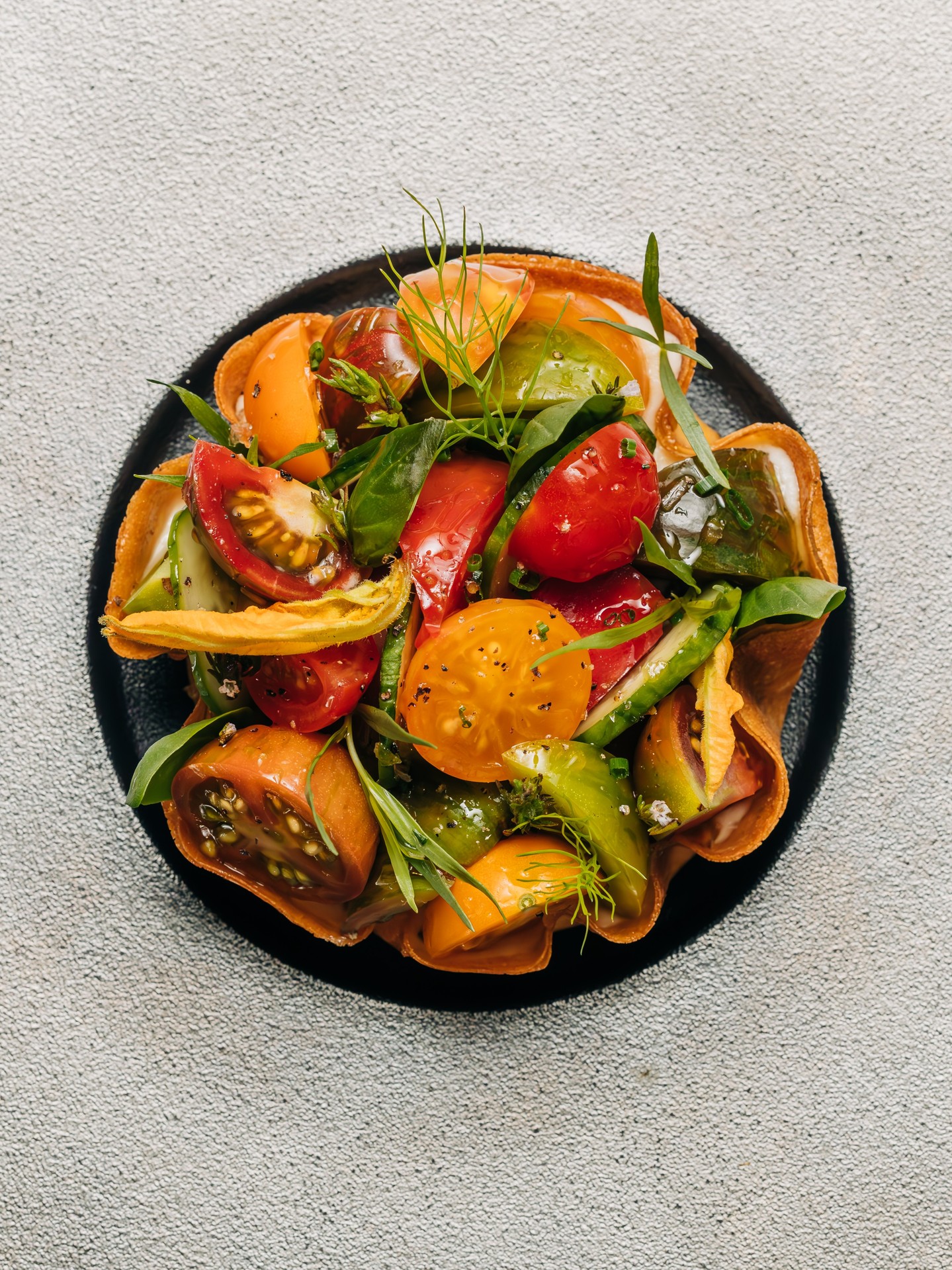A plate of heirloom tomatoes and herbs at RPM Italian in Chicago