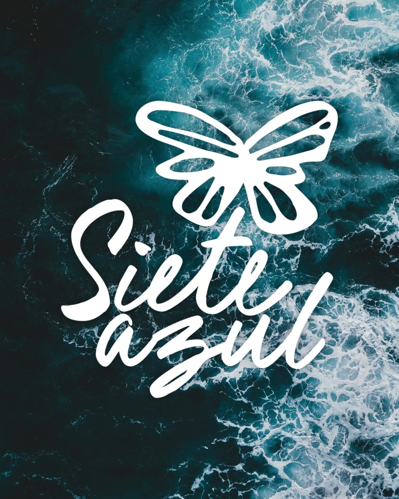 The white Siete Azul butterfly logo over crashing teal ocean waves