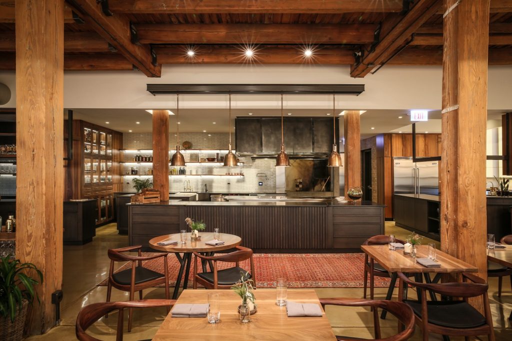 Smyth Chicago dining room with warm timber, low light and the open kitchen in the West Loop