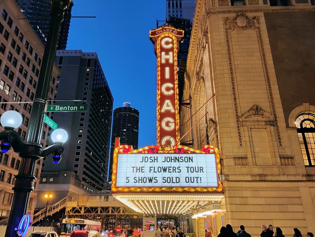 The Chicago Theatre marquee lit up at dusk on State Street in the Loop
